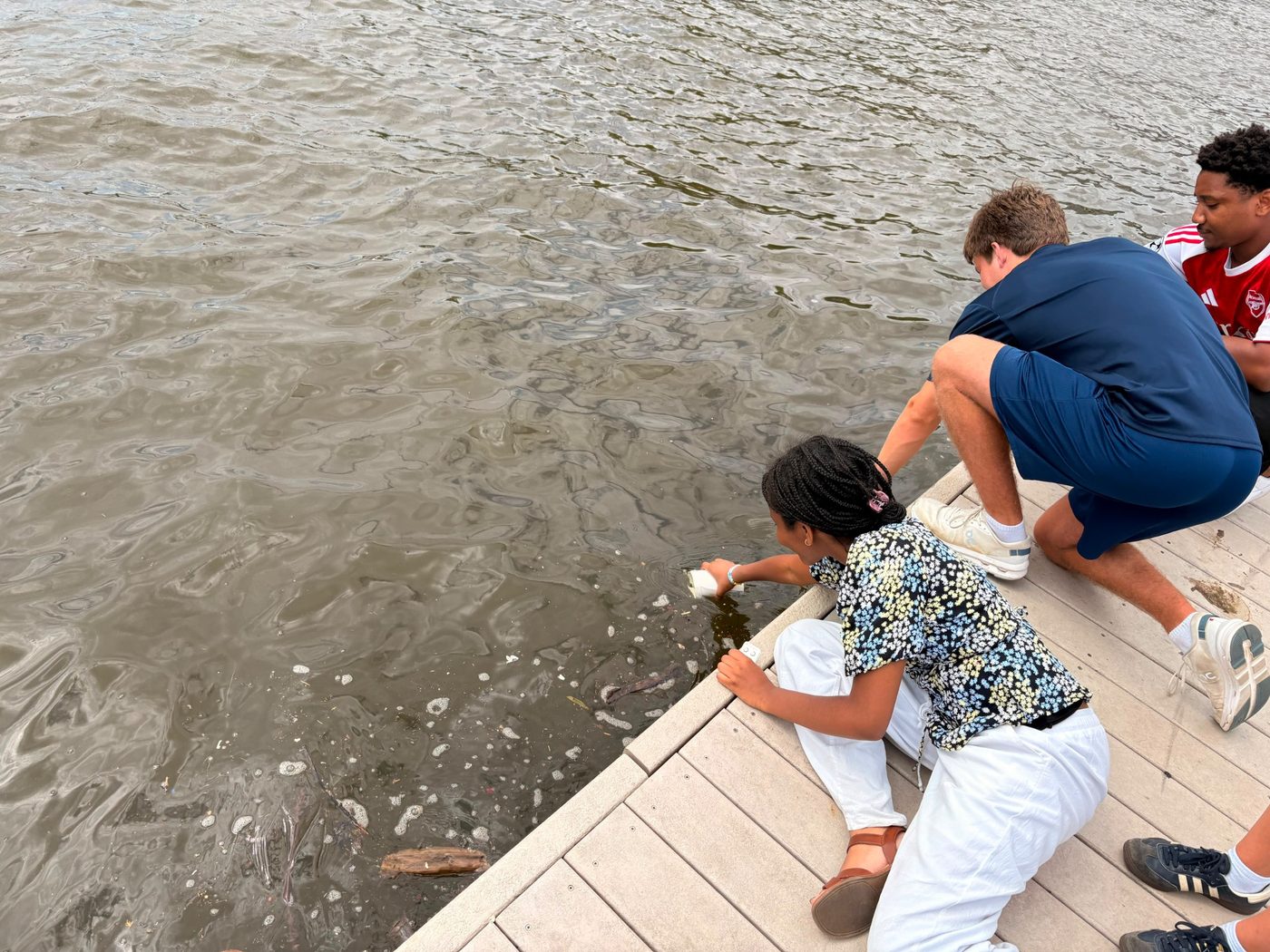 Fellows observing water at the Anacostia River&rsquo;s edge.